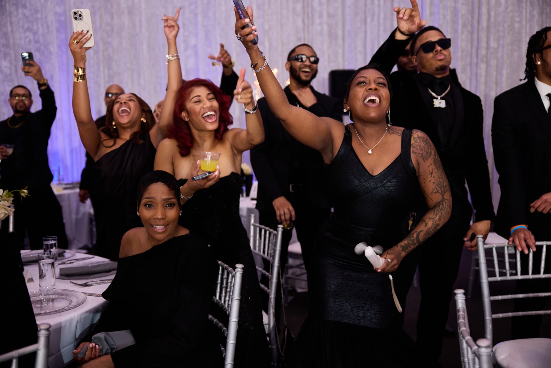 Wedding guests cheering and celebrating on the dance floor at a DMV reception