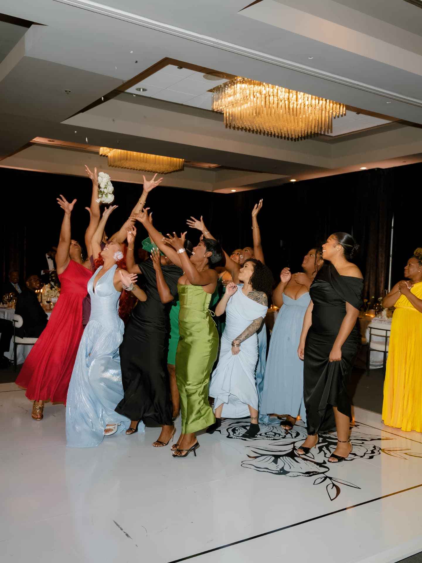 Bouquet toss moment on the reception dance floor