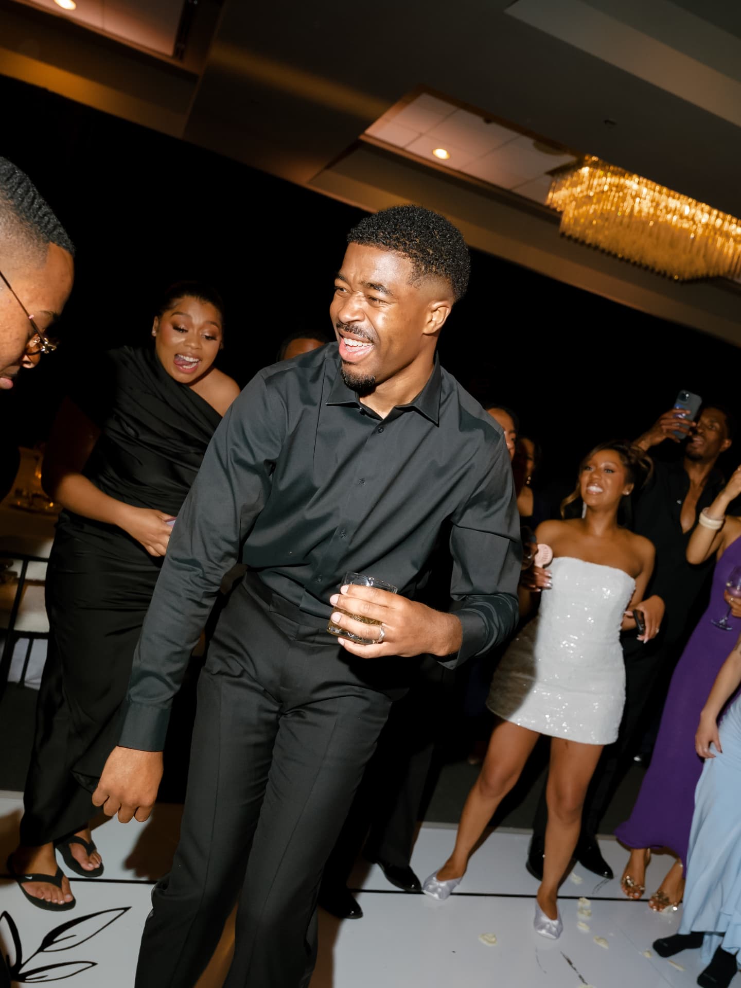 Guests dancing and laughing at a wedding reception