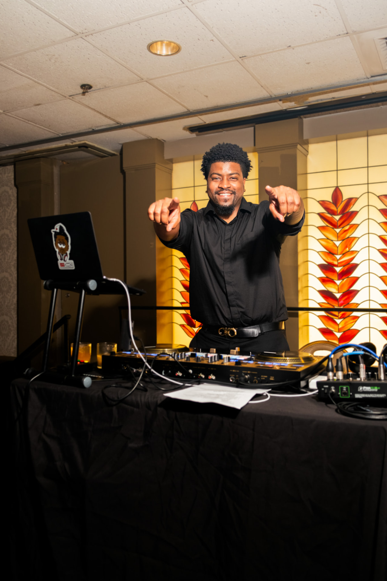 Darryl 'DMC' McDaniel behind the DJ decks at a formal event