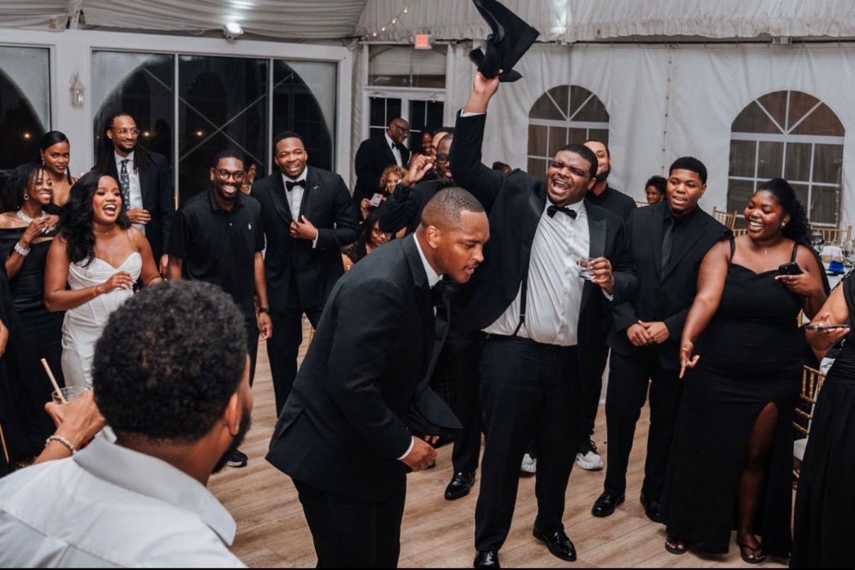 Wedding guests celebrating together at a tented reception in Maryland